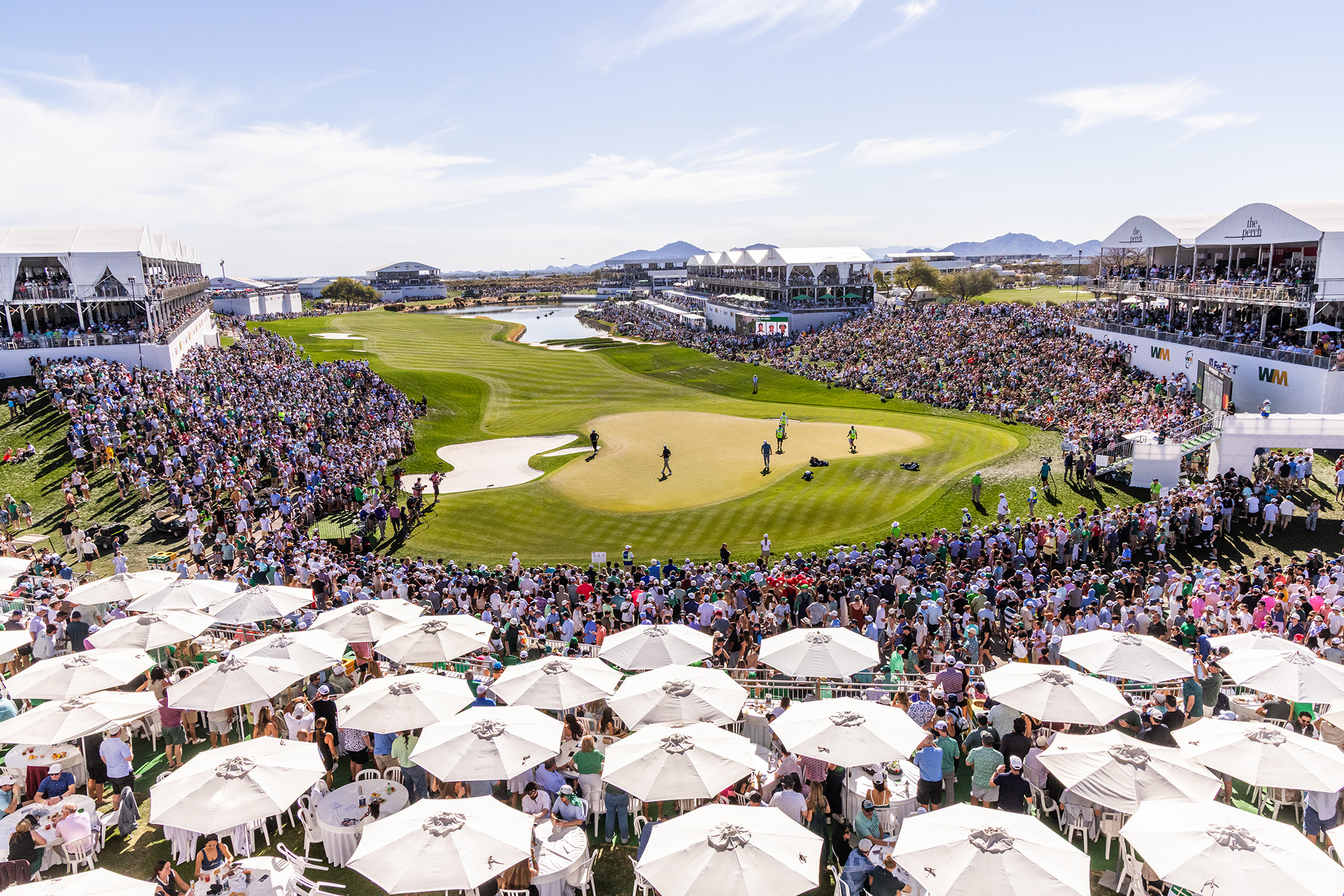 A large crowd surrounding the 18th green at the WM Phoenix Open