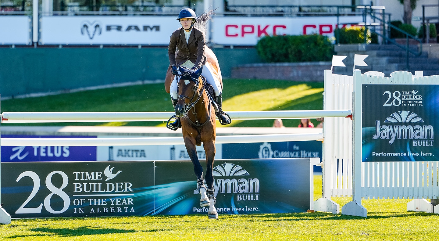 Lillie Keenan (USA) and Kick On Triumph in Jayman BUILT Cup 1.55m at Spruce Meadows